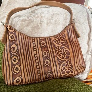 Danier Leather shoulder bag with a tooled design.